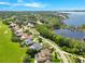 Overhead view featuring golf course, homes, and lake at 5913 Masters Blvd, Orlando, FL 32819