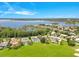 Picturesque aerial view of luxury homes nestled between a golf course and tranquil lake at 5913 Masters Blvd, Orlando, FL 32819