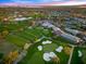 Aerial shot of a golf course, clubhouse and surrounding landscape during sunset at 5913 Masters Blvd, Orlando, FL 32819