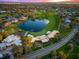Aerial view of a golf course with a pond, set among residential homes and lush greenery at 5913 Masters Blvd, Orlando, FL 32819