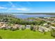 Expansive aerial view showcasing waterfront homes, lush landscapes, and a serene lake at 5913 Masters Blvd, Orlando, FL 32819