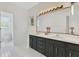 Bathroom featuring double vanity, tile flooring, and well-lit mirror at 5913 Masters Blvd, Orlando, FL 32819