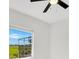 Bright bedroom features neutral walls, ceiling fan, and backyard view from window at 5913 Masters Blvd, Orlando, FL 32819