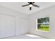 Bedroom with a ceiling fan and view of backyard from window at 5913 Masters Blvd, Orlando, FL 32819