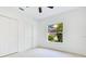 Bright bedroom features closet, carpet flooring, and backyard view from window at 5913 Masters Blvd, Orlando, FL 32819