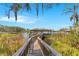 Scenic boardwalk leading to a covered dock, surrounded by natural beauty and serene waterfront views at 5913 Masters Blvd, Orlando, FL 32819