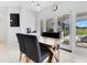 Dining room with modern lighting and views of screened in porch and pool outside the sliding glass doors at 5913 Masters Blvd, Orlando, FL 32819