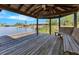 Covered dock featuring a wooden bench with a view of the calm waters and boat docks at 5913 Masters Blvd, Orlando, FL 32819