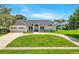 Beautifully landscaped single-story home with three-car garage and circular driveway at 5913 Masters Blvd, Orlando, FL 32819