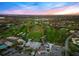 Stunning aerial view of a manicured golf course and clubhouse under a colorful sky, ideal for upscale living at 5913 Masters Blvd, Orlando, FL 32819