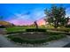 Golf statue on a manicured course against a backdrop of a colorful sunset sky at 5913 Masters Blvd, Orlando, FL 32819