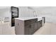 Kitchen island featuring bar seating with quartz countertop, farmhouse sink and modern appliances at 5913 Masters Blvd, Orlando, FL 32819