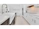 Kitchen with farmhouse sink, white cabinets, stainless steel appliances, and quartz countertops at 5913 Masters Blvd, Orlando, FL 32819