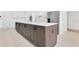 Kitchen island featuring bar seating with quartz countertop, and modern appliances at 5913 Masters Blvd, Orlando, FL 32819