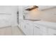 Kitchen with white cabinets, quartz countertops, stainless steel appliances, and cooktop at 5913 Masters Blvd, Orlando, FL 32819