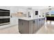 Spacious kitchen with island featuring bar seating, white cabinets, stainless steel appliances at 5913 Masters Blvd, Orlando, FL 32819