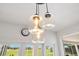 Modern pendant lights illuminate kitchen area with views of the screened-in pool at 5913 Masters Blvd, Orlando, FL 32819