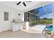 Covered patio with outdoor grill and views of the screened pool area at 5913 Masters Blvd, Orlando, FL 32819