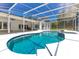 Large pool with screened enclosure, patio area, and lush landscaping at 5913 Masters Blvd, Orlando, FL 32819