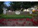 Stone sign with 'Bay Hill' inscription surrounded by lush green bushes and vibrant red flowers at 5913 Masters Blvd, Orlando, FL 32819