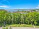 Street view of property backing to water, with lush trees and serene water views of a lake at 5913 Masters Blvd, Orlando, FL 32819