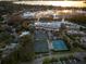 Aerial shot showcasing tennis courts and serene lake views, perfect for active living and scenic beauty at 5913 Masters Blvd, Orlando, FL 32819
