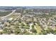 Aerial view of the community showcasing tree-lined streets, well-maintained homes, and proximity to local amenities at 644 Villa Ct, Clermont, FL 34711