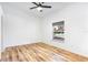 Inviting bedroom boasts wood-look flooring, ceiling fan, and a large window at 644 Villa Ct, Clermont, FL 34711
