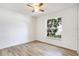 Bright bedroom featuring stylish wood-look flooring and a large window at 644 Villa Ct, Clermont, FL 34711