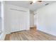 Bedroom featuring modern wood-look flooring and a closet with bi-fold doors at 644 Villa Ct, Clermont, FL 34711