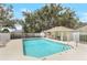 Beautiful community pool with a shaded cabana and crystal-clear water, offering a refreshing oasis for residents at 644 Villa Ct, Clermont, FL 34711