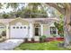 Charming single-story home featuring an attached garage and well-manicured landscaping at 644 Villa Ct, Clermont, FL 34711