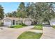 Charming single-story home with well-manicured lawn, mature trees, and driveway, offering a welcoming curb appeal at 644 Villa Ct, Clermont, FL 34711