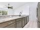 Well-lit kitchen featuring granite countertops, stainless steel appliances, and an open layout at 644 Villa Ct, Clermont, FL 34711