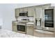 Modern kitchen with stainless steel appliances, granite countertops, and grey cabinetry at 644 Villa Ct, Clermont, FL 34711