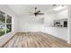 Bright living room with hard wood floors, ceiling fan, large window and open floor plan at 644 Villa Ct, Clermont, FL 34711