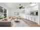 Bright open-concept living room showcasing modern decor and a seamless flow into the kitchen at 644 Villa Ct, Clermont, FL 34711
