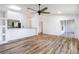 Open-concept living area with hard wood floors, ceiling fan, and seamless access to the kitchen at 644 Villa Ct, Clermont, FL 34711