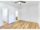 Spacious bedroom with wood-look floors and access to the bathroom and closet at 644 Villa Ct, Clermont, FL 34711