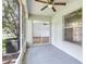 Relaxing screened porch with ceiling fan and view to the spacious living room, a great space to unwind and enjoy the outdoors at 644 Villa Ct, Clermont, FL 34711