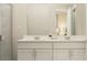 Bathroom featuring double vanity with white cabinets and quartz countertop at 7342 Ivy Tendril Ave, Orlando, FL 32829