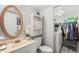 Bathroom with single sink vanity, oval mirror, and storage, with laundry area and washer access at 7466 Canford Ct # 25, Winter Park, FL 32792