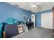 Bedroom features blue walls and a ceiling fan and an interior door at 7466 Canford Ct # 25, Winter Park, FL 32792