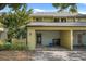 Townhouse exterior with a carport, fenced yard, and mature trees at 7466 Canford Ct # 25, Winter Park, FL 32792