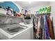 View of laundry room featuring front load washer and dryer with storage above at 7466 Canford Ct # 25, Winter Park, FL 32792