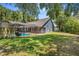 Spacious backyard features a screened pool area, lush lawn, and mature trees at 7838 Rollingridge Ct, Orlando, FL 32835