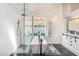 Bright bathroom featuring a sleek shower and soaking tub, and a modern vanity with marble countertop at 7838 Rollingridge Ct, Orlando, FL 32835