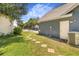 Landscaped side yard with stone pathway and convenient side entry door at 7838 Rollingridge Ct, Orlando, FL 32835