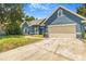 Charming blue home with a well-manicured lawn and inviting curb appeal, featuring a spacious two-car garage at 7838 Rollingridge Ct, Orlando, FL 32835