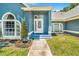 Inviting front porch with a glass door and lovely landscaping, creating a welcoming entrance to the home at 7838 Rollingridge Ct, Orlando, FL 32835